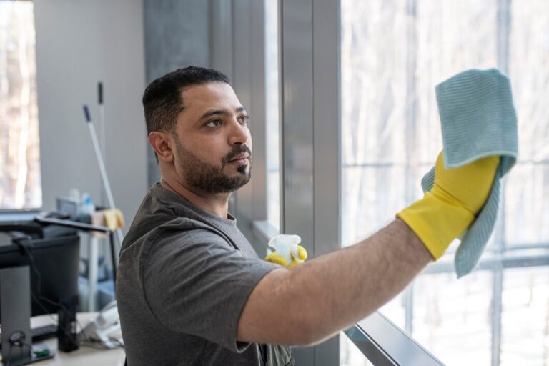 man cleaning window