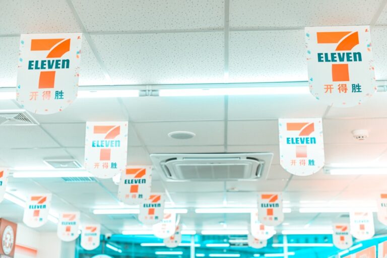 Ceiling view of a retail store with clean, white tiles and 7-Eleven banners, illustrating a spotless environment for effective retail cleaning.