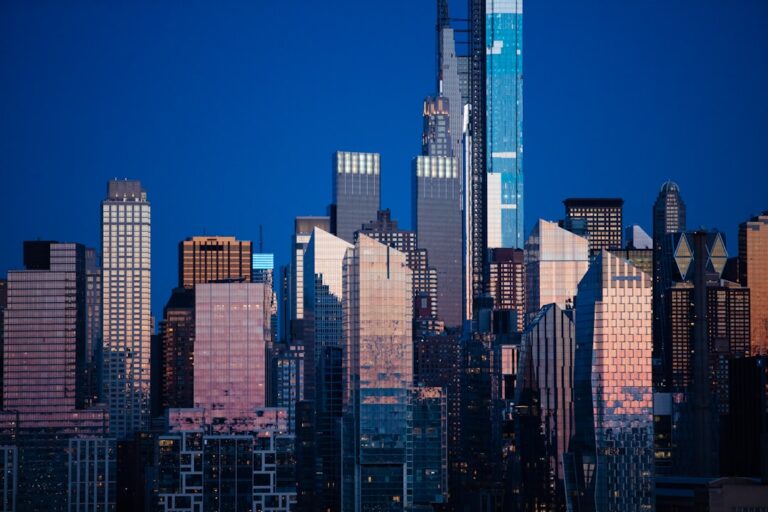 New York City skyline at dusk, showcasing glass buildings reflecting light, illustrating the need for professional cleaning services.