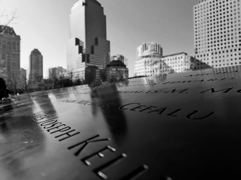 Reflective surface of a New York memorial with skyscrapers in the background, symbolizing the importance of professional maintenance services.