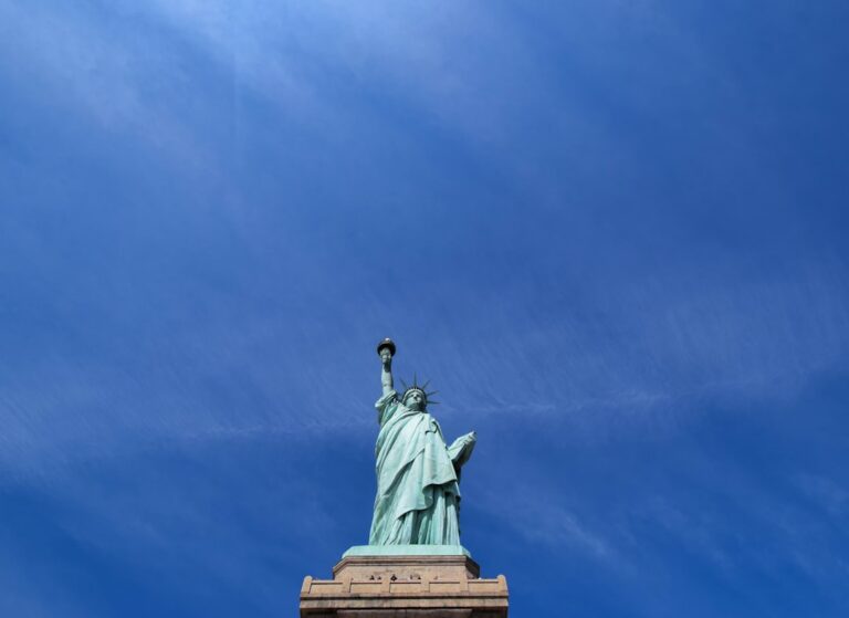 Statue of Liberty against a clear blue sky, symbolizing New York, the setting for hiring professional cleaning services.