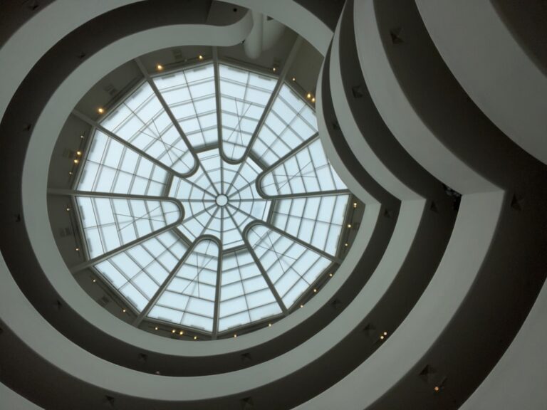 Looking up at the modern, clean spiral architecture of a New York building, emphasizing professional cleaning benefits for such spaces.