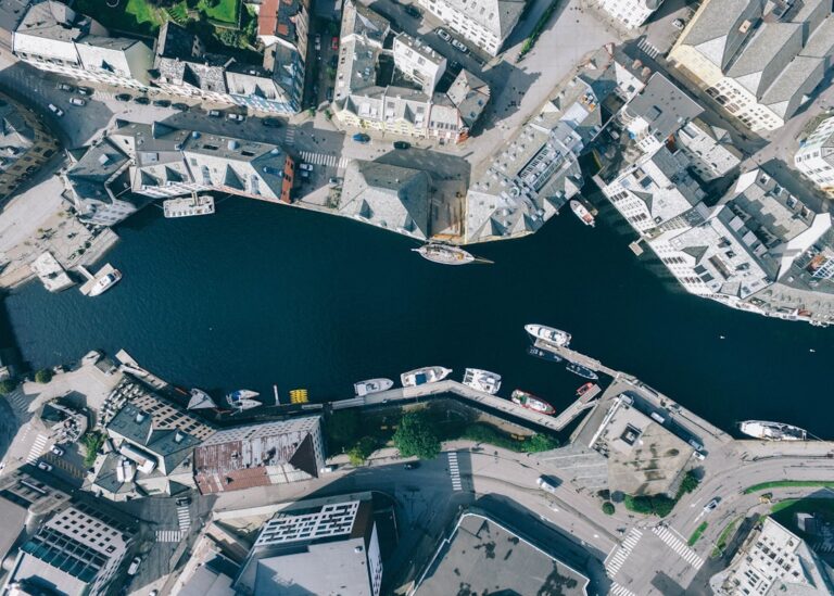 Aerial view of a city canal surrounded by buildings and boats, illustrating the bustling urban setting near Gramercy Cleaners.